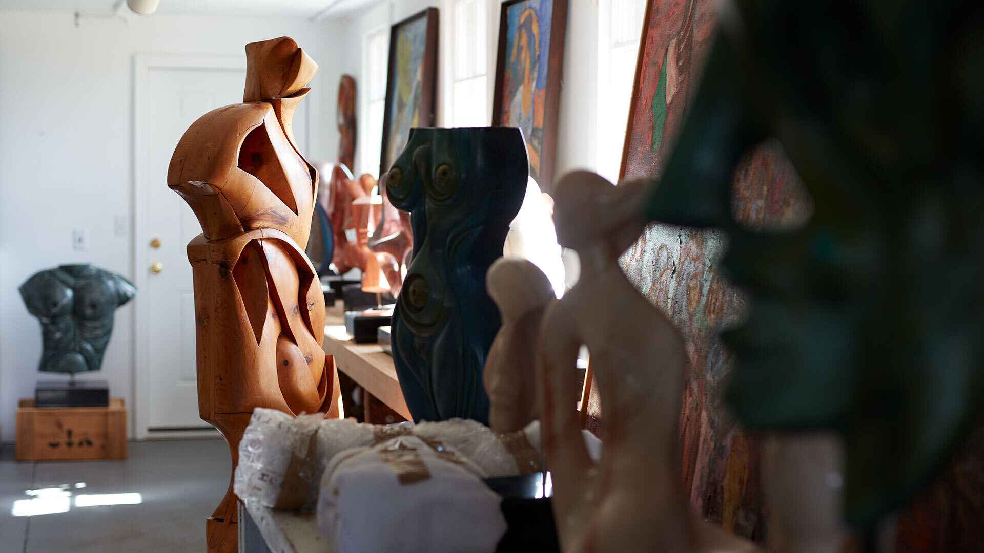 A photo of a large and varied sculpture collection stored indoors.