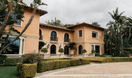 A photo of the front of a large mediterranean style house.