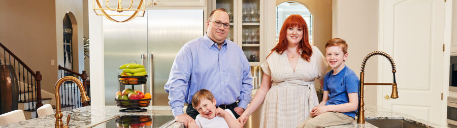 PURE members Christina and Craig Dillard with their children in their kitchen.