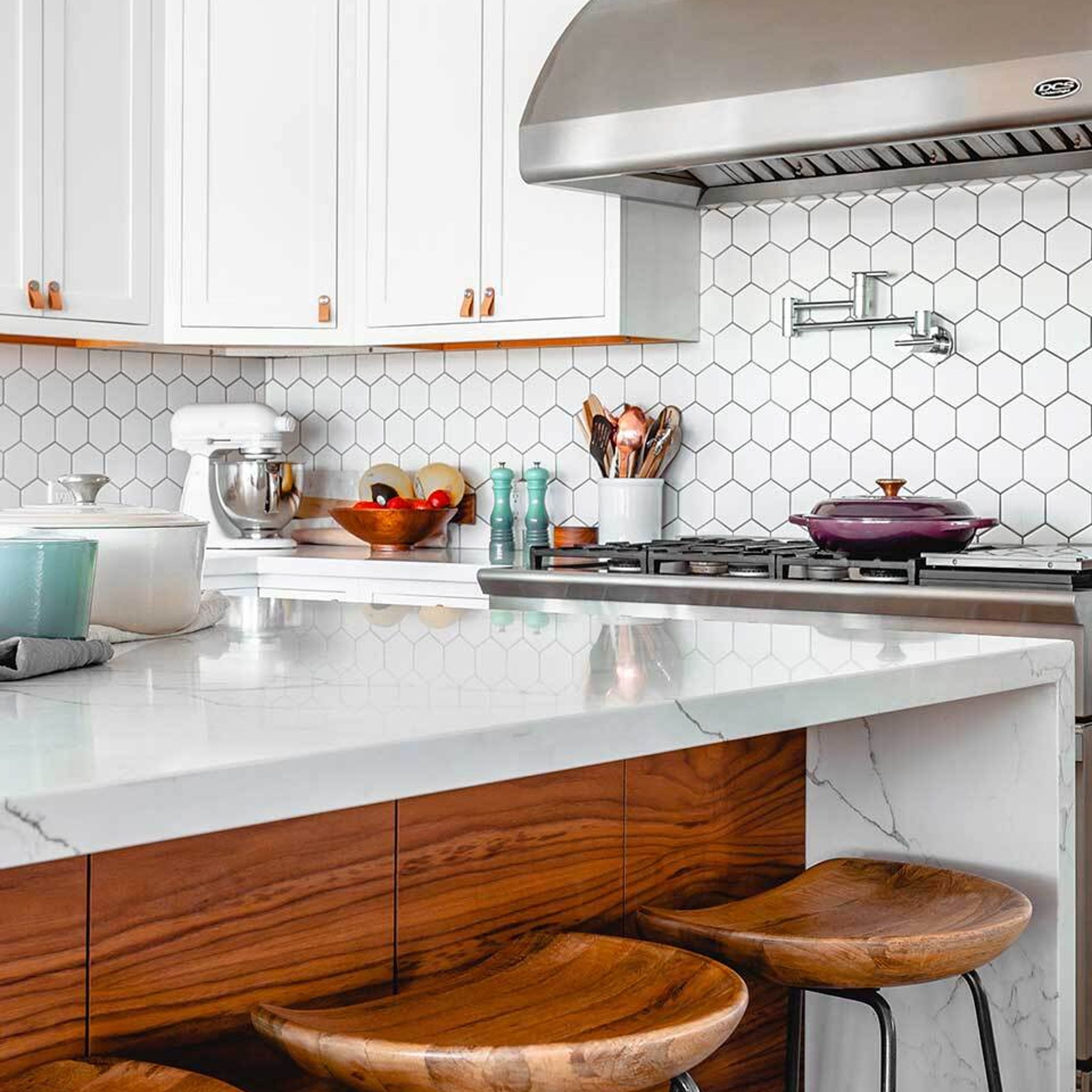 A photo of the inside of a bright, well-designed kitchen in an apartment.
