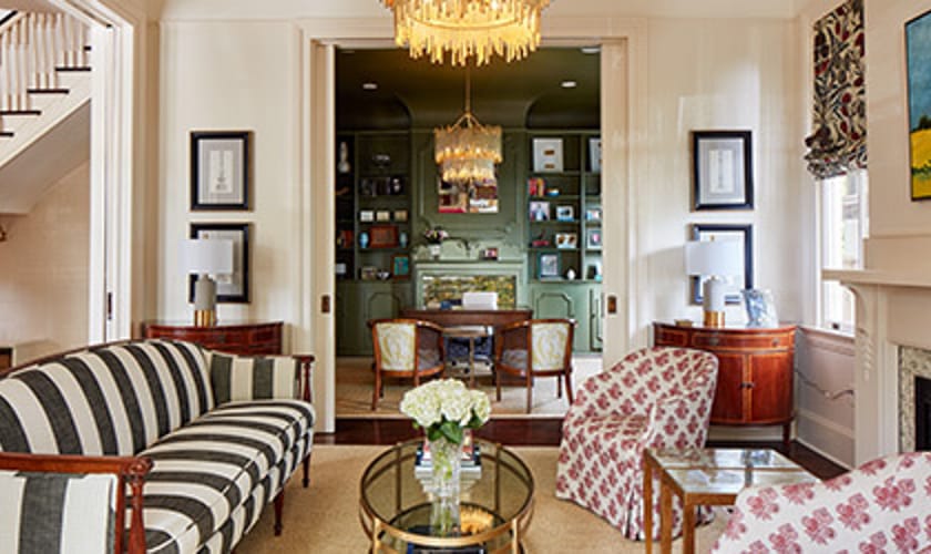 Wide angle view of a tastefully decorated living room with connected dining room
